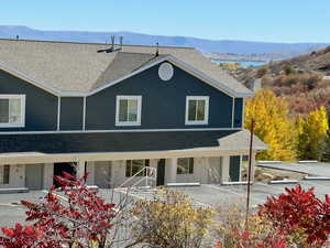Back of property featuring a mountain view, a shingled roof, board and batten siding, and a porch