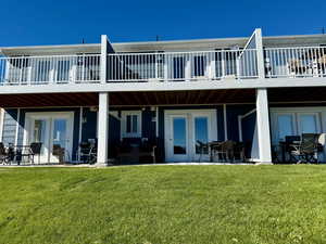 Back of property with a patio, a lawn, and outdoor dining area