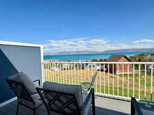Balcony with a water and mountain view