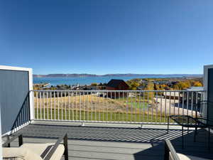 Balcony with a water and mountain view