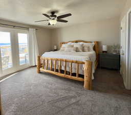 Bedroom featuring access to exterior, carpet floors, a textured ceiling, and ceiling fan