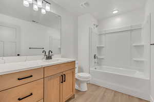 Full bathroom with light wood-type flooring, bathtub / shower combination, and vanity