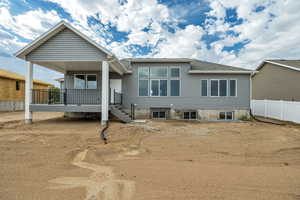 Rear view of property featuring a wooden deck