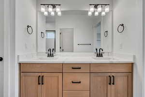 Full bath featuring double vanity