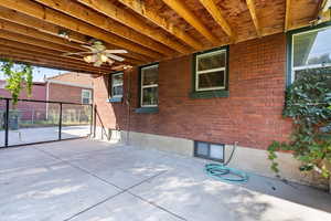 Covered patio and is gated from the yard which works great with dogs. Ceiling fans make for a wonderful summer seating area.