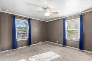 Bedroom on main level includes the ceiling fan and drapes