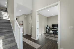 Stairway with wood finished floors and recessed lighting