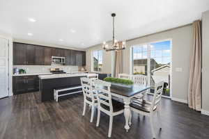 Dining room featuring a chandelier, dark wood finished floors, and recessed lighting