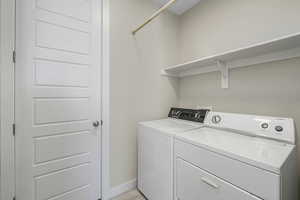 Washroom with washer, dryer and storage closet