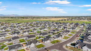 Aerial view of property's location featuring a water and mountain view and nearby suburban area