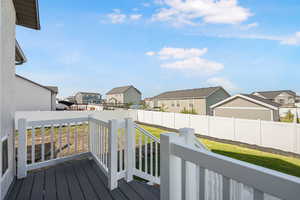 Wooden deck featuring a residential view and a fenced backyard