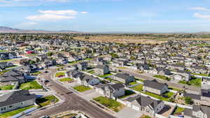 Aerial overview of property's location featuring nearby suburban area and a mountainous background