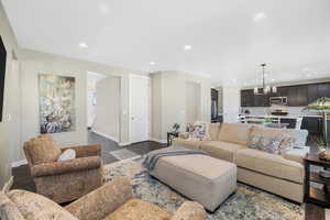 Living room with recessed lighting, dark wood-type flooring