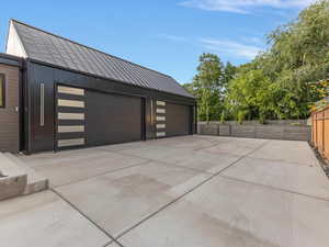 Garage featuring concrete driveway