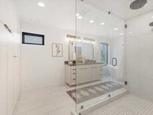Full bath with vanity, a stall shower, light tile patterned floors, recessed lighting, and a freestanding bath
