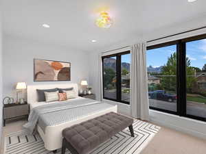 Bedroom with a mountain view, recessed lighting, access to exterior, and light carpet