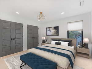 Bedroom with carpet floors, multiple closets, and recessed lighting