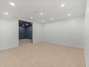 Unfurnished room with light carpet and recessed lighting