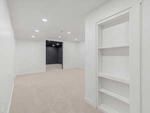 Hall featuring recessed lighting and light carpet