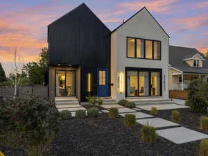 Front of house at dusk featuring board and batten siding