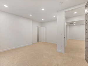 Unfurnished bedroom featuring recessed lighting and light colored carpet