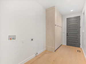Washroom with light wood finished floors, hookup for an electric dryer, washer hookup, and recessed lighting