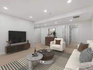 Carpeted living room featuring recessed lighting and baseboards