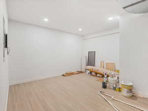 Interior space with light wood finished floors and recessed lighting