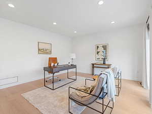 Office or living room area with recessed lighting and light wood-style floors