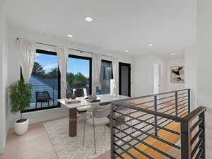 Dining area with recessed lighting, light wood finished floors, and a desk