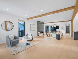 Sitting room with beamed ceiling, recessed lighting, and light wood finished floors