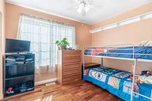 Bedroom with wood finished floors and ceiling fan