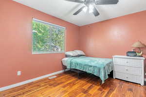 Bedroom with wood finished floors and a ceiling fan