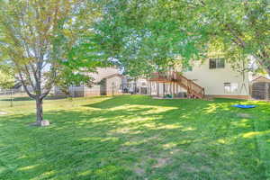 Fenced backyard with stairway and a deck