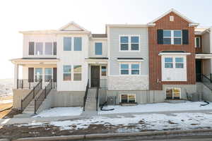 View of front facade featuring stone siding and board and batten siding