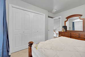 Bedroom with a closet and a textured ceiling
