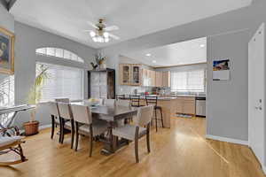 Dining room with light wood-style floors, a ceiling fan, and recessed lighting