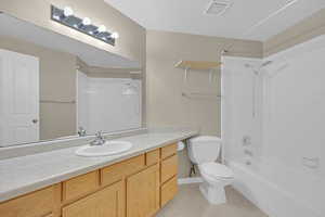 Full bathroom featuring tub / shower combination, vanity, and light tile patterned floors