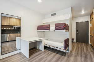 Bedroom with recessed lighting and dark wood-style flooring