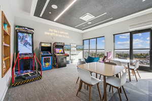 Dining room with carpet floors and a wall mounted AC