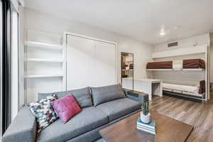 Living room with wood finished floors and recessed lighting