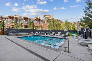 Community pool featuring a hot tub
