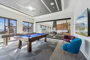 Playroom with billiards table, carpet flooring, recessed lighting, and a raised ceiling