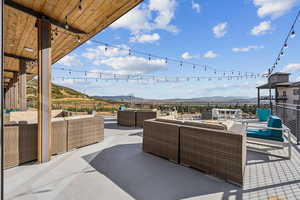 View of patio with an outdoor living space and a mountain view