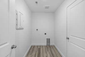 Laundry area featuring dark wood finished floors, washer hookup, hookup for an electric dryer, and electric panel