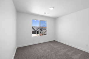 Carpeted spare room featuring a mountain view and a textured ceiling