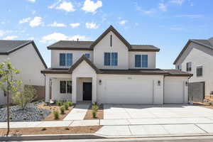 Traditional-style house featuring concrete driveway, stucco siding, and an attached garage