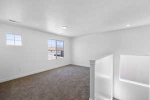 Unfurnished room with carpet flooring and baseboards
