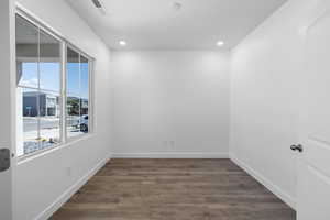 Unfurnished room with dark wood-type flooring and recessed lighting