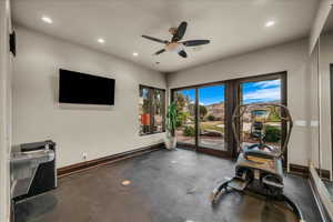 Exercise area with recessed lighting, a ceiling fan, and concrete flooring